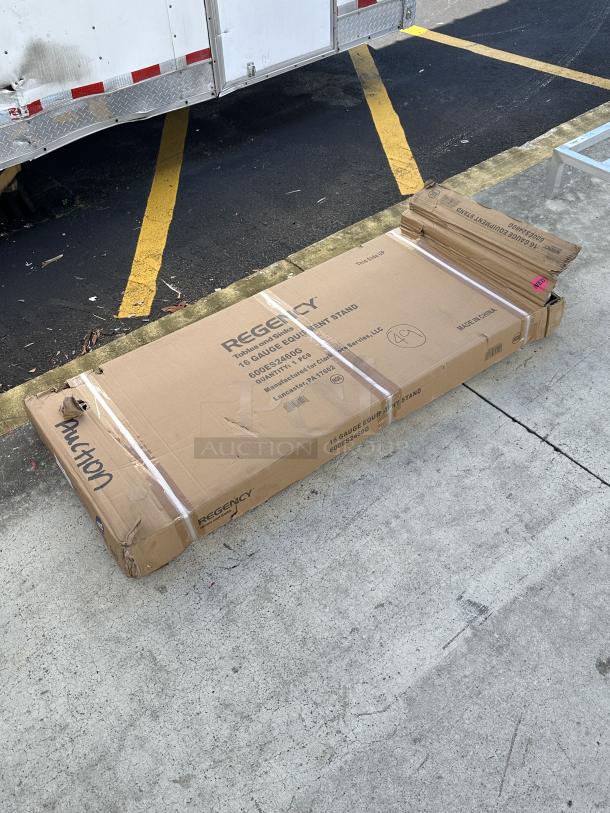 Regency 24" x 60" equipment stand box; model 600ES2460G, 16-gauge stainless steel, galvanized undershelf. Box marked "Auction."