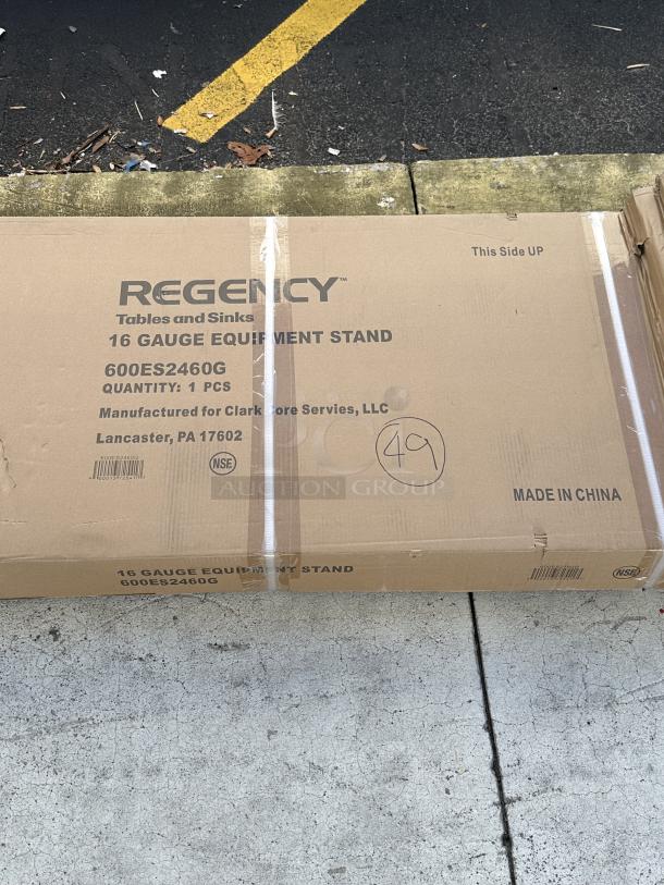 Regency 24" x 60" 16-Gauge Stainless Steel Equipment Stand, Model 600ES2460G, new scratch and dent condition, with galvanized undershelf, box marked with item details.