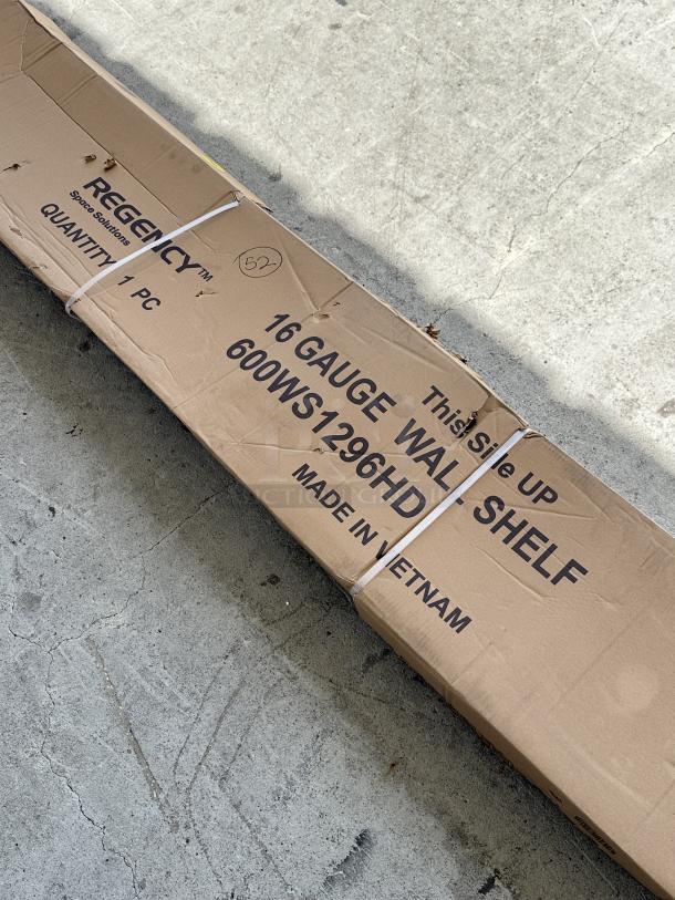 Brand new Regency 16-gauge stainless steel wall shelf, model 600WS1296HD, in packaging. Scratch and dent.