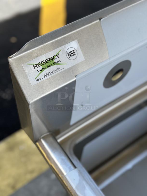 Brand new Regency sink with right drainboard, model 600S1182418R, NSF certified, minor scratches, label visible.