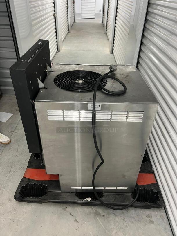 Frozen Beverage Dispensers 77X series, stainless steel body, visible power cord, in used condition on a storage pallet.