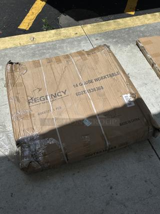 Regency Spec Line commercial work table, model 600TSS3636S, new with scratches, in original packaging with visible marks.