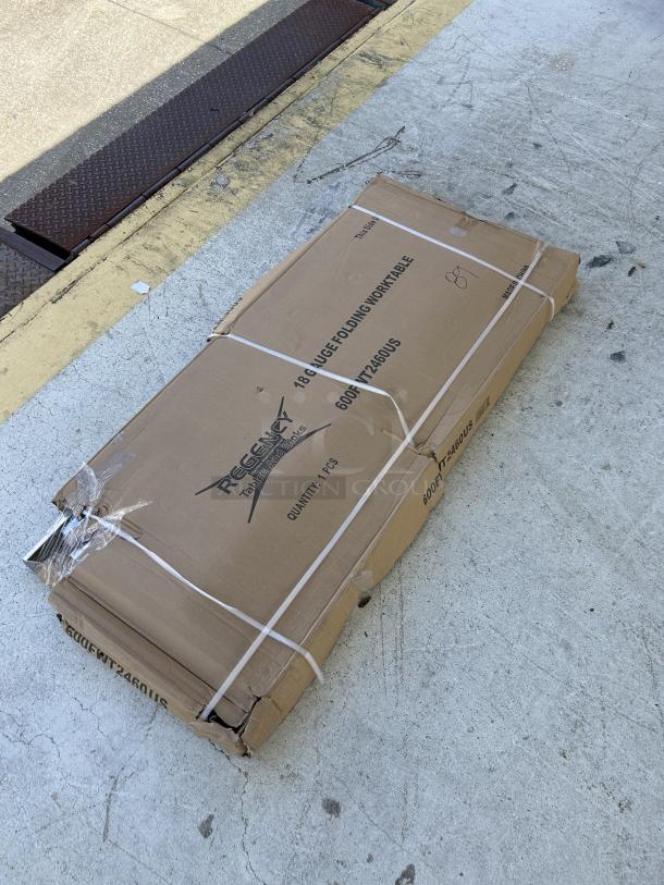 Regency 24"x60" stainless steel folding work table, model 600FWT246OUS, new with scratch and dent, boxed.