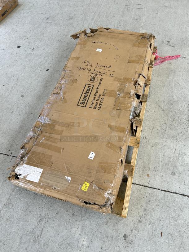 Damaged packaging of a brand new Steelton 30"x72" stainless steel work table, model 522ETSG30722, on pallet.