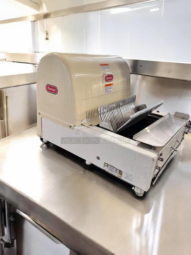 Berkel MB 1/2 bread slicer in excellent condition, 115V, fully tested, cream color, visible labels, stainless steel blades.