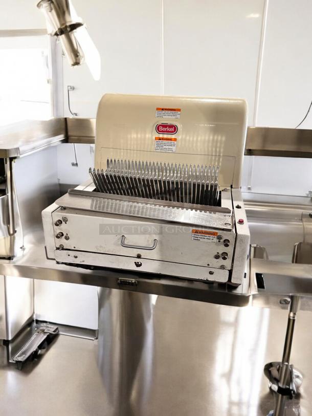 Berkel MB 1/2 bread slicer in excellent condition, 115V, fully tested. Visible Berkel branding and warning labels.