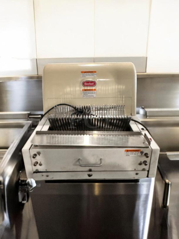 Berkel MB 1/2 bread slicer in excellent condition, 115V, fully tested and working, visible Berkel logo and safety labels.
