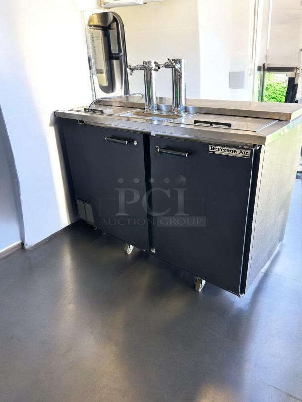 Beverage-Air DD58C draft beer dispenser in excellent condition, features dual taps, stainless steel top, branded logo, and casters.