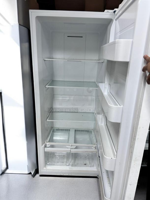 Insignia NS-UZ21WH0 upright freezer, 21 cu. ft., excellent condition, shelves and door compartments visible, fully tested.