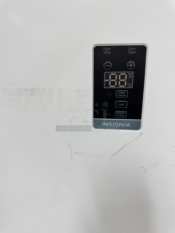 Insignia NS-UZ21WH0 upright freezer control panel, displaying temperature. Model and brand label visible.