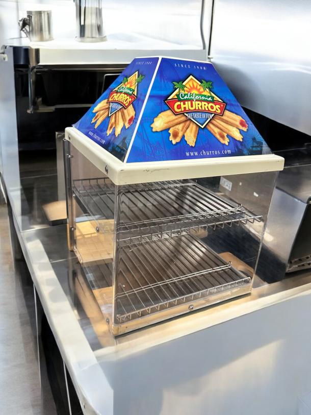 Wisco 680-1 food warmer/display cabinet, excellent condition, 120V, fully tested, features 'California Churros' branding.