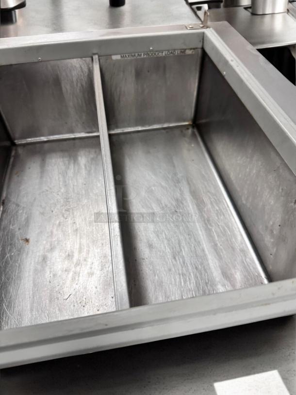 Wisco 680-1 countertop warmer, excellent condition, stainless steel interior, divider, "MAXIMUM PRODUCT LOAD LINE" label visible.