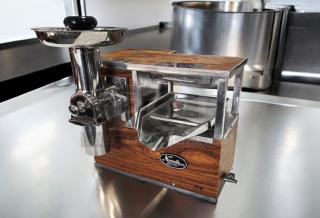 Brand new Norwalk Model 235 hydraulic press juicer, 110V, with wood and chrome design, in original packaging.