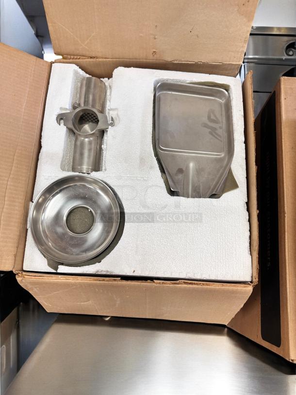 Brand new Norwalk Model 235 hydraulic press juicer, 110V, in original packaging with parts in protective foam.