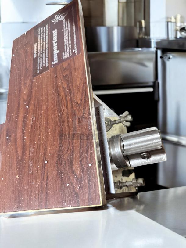 Brand new Norwalk Model 235 hydraulic press juicer, 110V, in original packaging. Features wood finish and visible instructions.