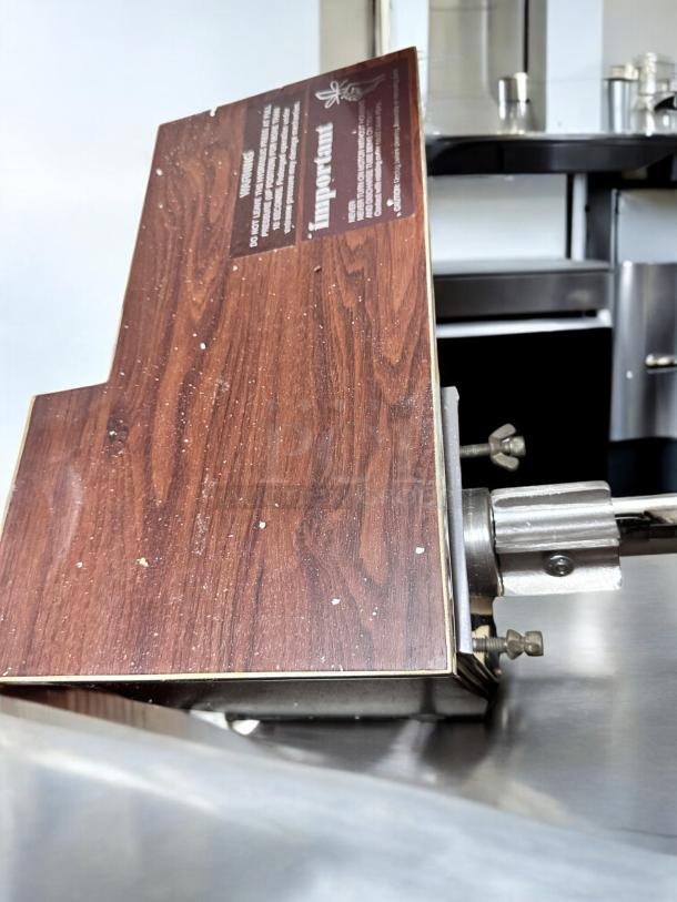Brand new Norwalk Model 235 hydraulic press juicer, 110V, in original packaging. Features a faux wood panel with label.