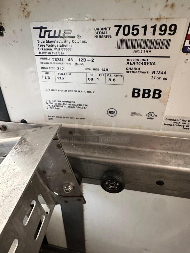 Alt text: True TSSU-48-12D-2 48" sandwich prep table label, showing model, serial, and voltage details, excellent condition.