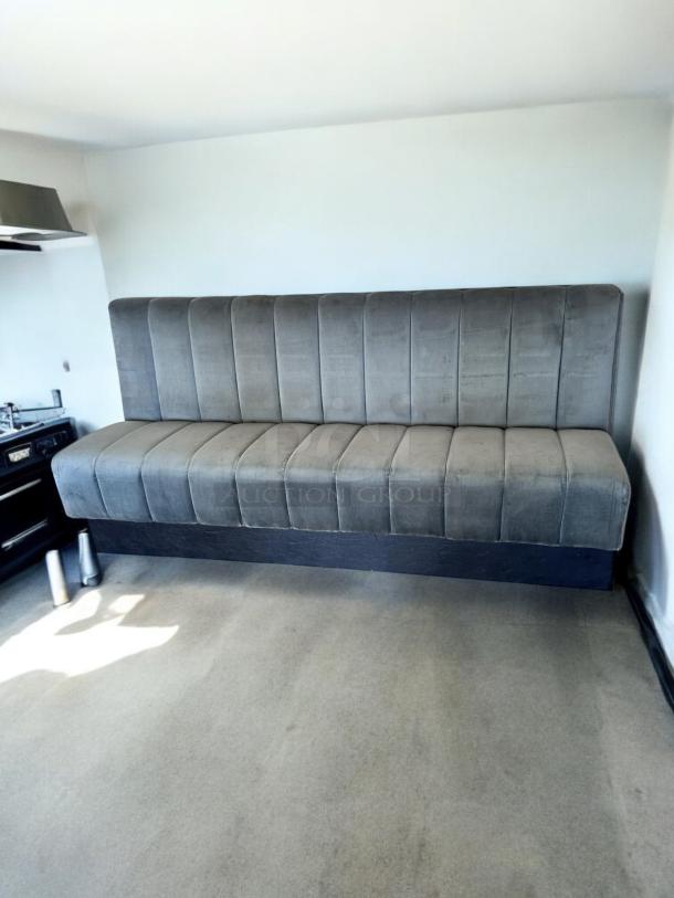 Upholstered restaurant booth, 82" wide, excellent condition, gray fabric, vertical tufting, fully tested, ready for use.