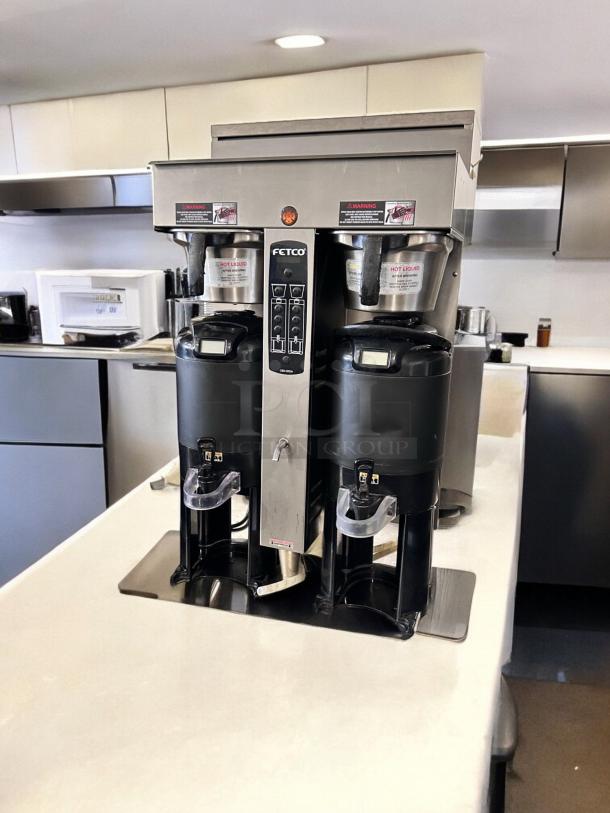 Fetco CBS-2052e dual station coffee brewer in excellent condition, 208-240V, fully tested, stainless steel finish, visible control panel.