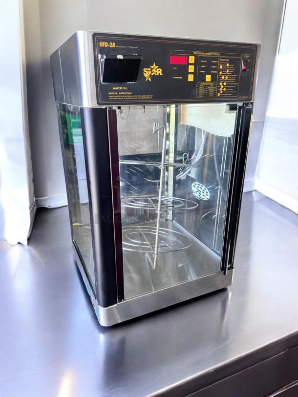 Star HFD-2A heated display cabinet, excellent condition, with rotating racks, control panel, and visible labels, 120V.