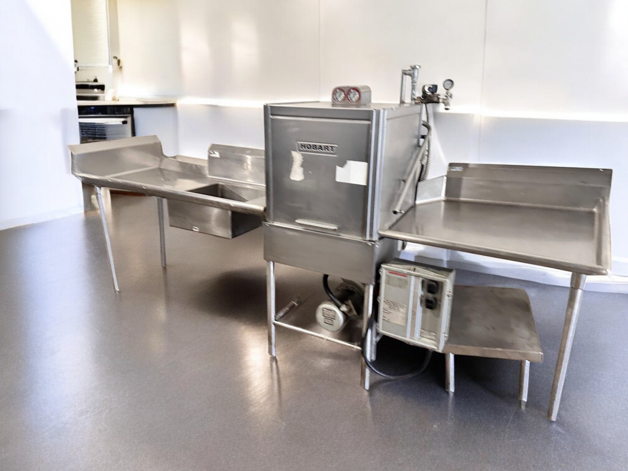 Complete pass-through dishwasher system with dirty side and clean side tables