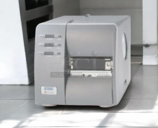 Brand New Datamax-O’Neil DMX-M-4210 industrial label printer, 300 DPI, high-performance printing, gray exterior.