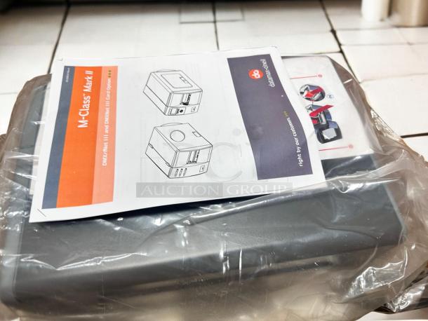 Brand new Datamax-O’Neil DMX-M-4210 industrial label printer, 300 DPI, in packaging with manual on top.
