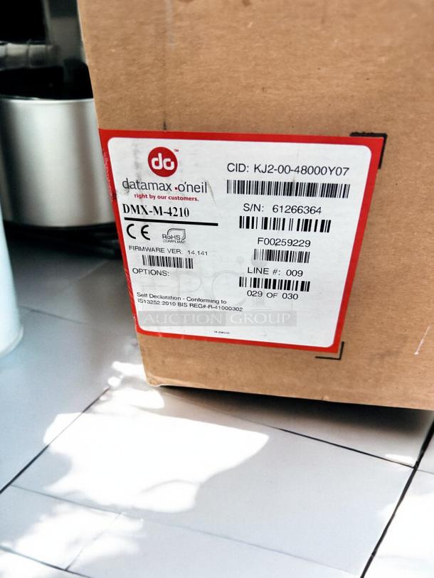 Datamax-O'Neil DMX-M-4210 industrial label printer box, featuring a 300 DPI high-performance printing capability. Serial number 61266364.