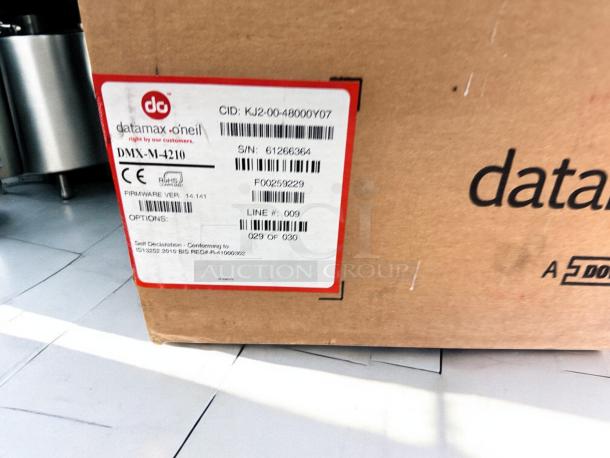 Datamax-O’Neil DMX-M-4210 label printer box, brand new, 300 DPI. Label shows model, serial number, and compliance info.