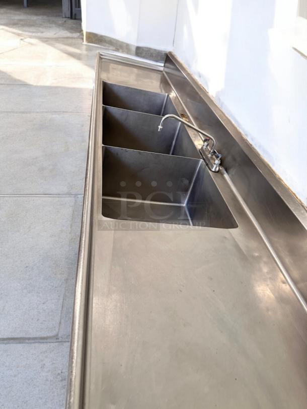 Stainless steel 3-compartment sink with dual drainboards, excellent condition, 132"L x 31"W x 42"H, fully tested.