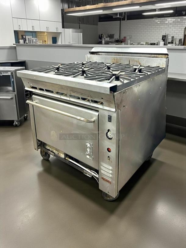 Montague 136-5 Legend 36" heavy-duty gas range with six open burners, stainless steel, fully tested, excellent condition.