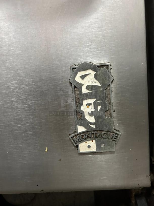 Montague 136-5 Legend 36" gas range, six burners, amazing condition, tested and working. Montague logo visible.