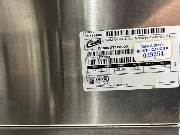 Curtis D1000GT12A000 coffee brewer label, showing model, serial number, and specs: 220V, 23.2 amps, 5100 watts.