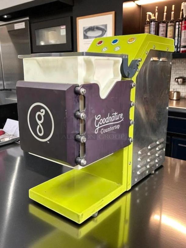 Excellent condition Goodnature GT7 cold pressed juicer, tested and working, with brand markings and vibrant yellow accents.