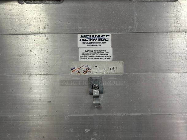 New Age 1290 mobile enclosed pan rack, excellent condition, holds 40 pans, HD base, visible label with cleaning instructions.