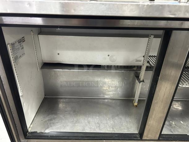 True TUC-60F-HC 60" stainless steel undercounter freezer. Interior view, clean with shelf supports. Fully tested, working condition.