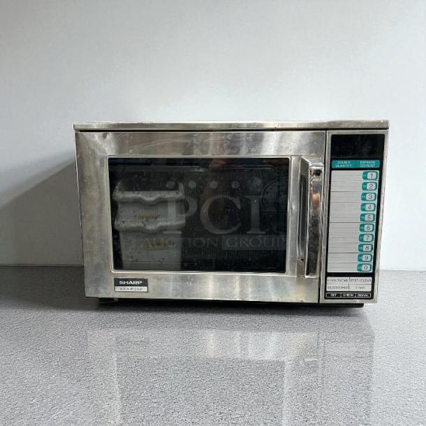 Sharp R23GTF stainless steel commercial microwave oven, 1600 watts, fully tested and working. Front controls, visible handle.