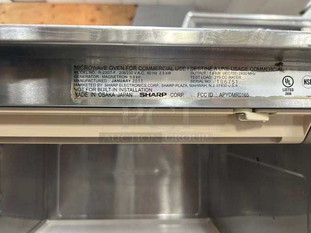 Sharp R23GTF stainless steel commercial microwave oven label, 1600 watts, model details and serial number 1106751.