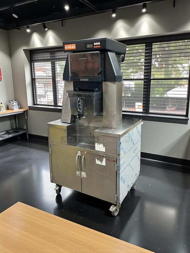 Zummo Z40-N commercial juicer, stainless steel, model Z40-N, fully tested, excellent condition, 110-120V, on casters.