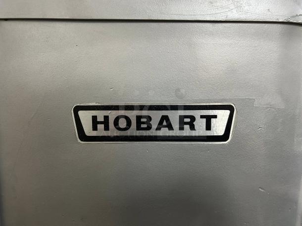 HOBART H-600T mixer, 60 Qt, single phase 230V; great condition, fully tested. Visible Hobart logo on gray surface.
