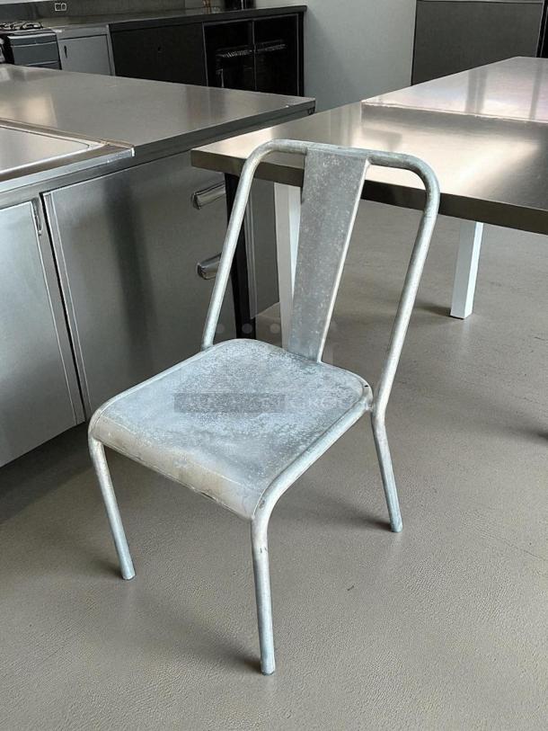 Silver aluminum outdoor dining chair in great condition, fully tested. Sturdy design, suitable for modern settings.
