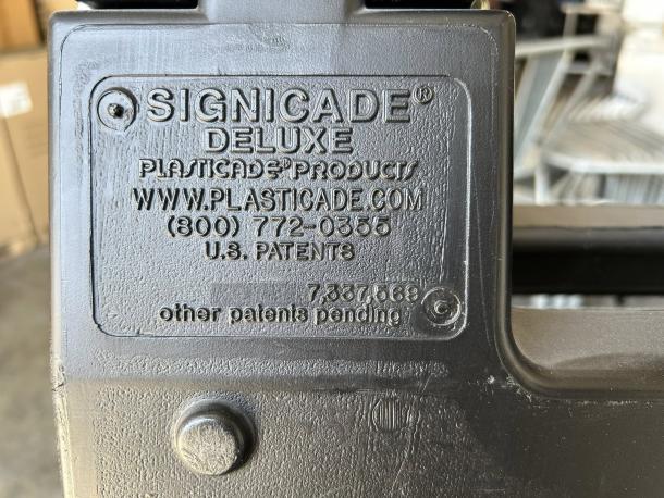 Signicade Deluxe plastic A-frame sign, black, 24x36", excellent condition. Features U.S. patent and contact info on label.