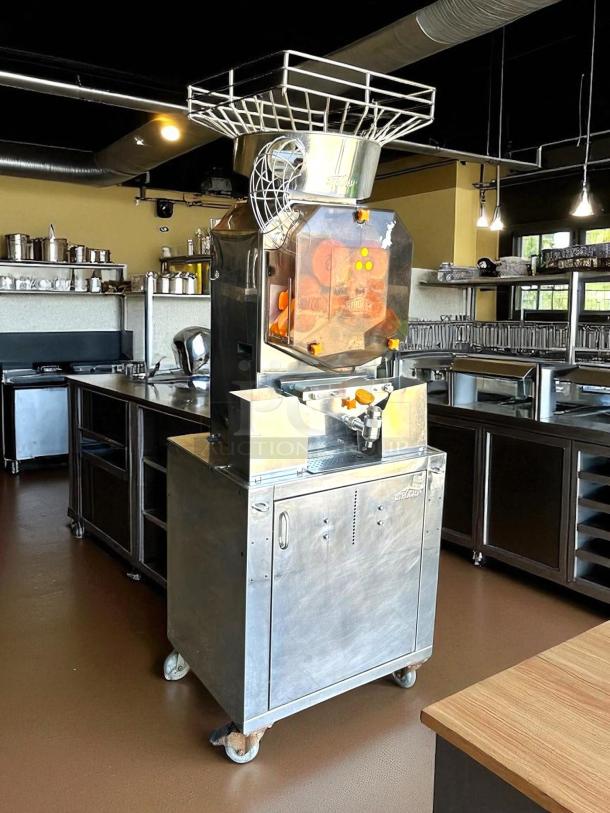 Citrocasa 8000 XB Advance Citrus Juicer in amazing condition, fully tested, stainless steel body, visible internal gears, on wheels.