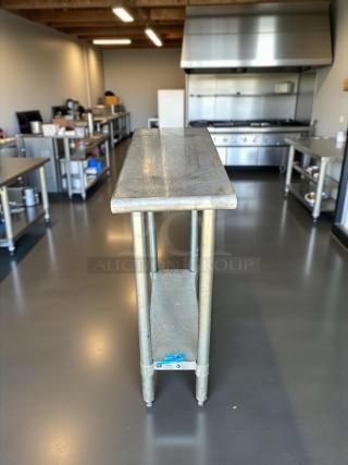 Stainless steel worktop table in great condition, featuring a sturdy design with a polished surface, ideal for industrial use.