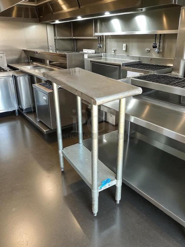 Stainless steel worktop table in great condition, sturdy with lower shelf, ideal for kitchen use, reliable and durable.