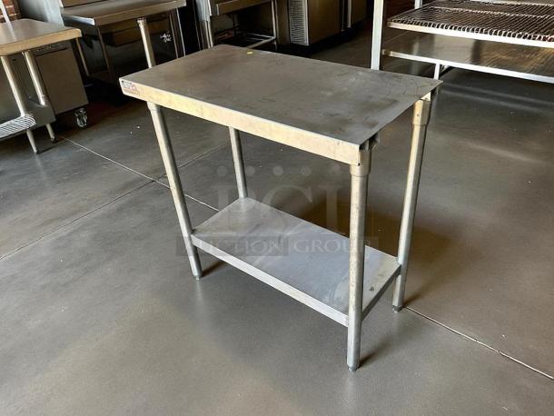 Stainless steel worktop table, great condition, features lower shelf, durable finish, ideal for commercial use.