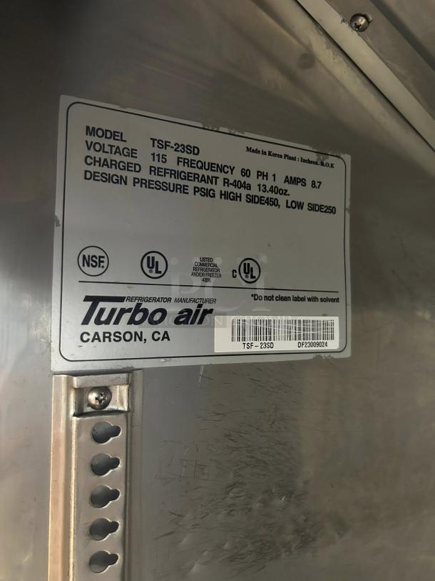Turbo Air TSF-23SD-N label shows model, voltage, frequency, refrigerant, and design pressure. Made in Korea, UL listed.
