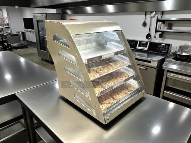 Stainless steel Subway cookie display case in excellent condition, compact design, with clear shelves showcasing cookies.