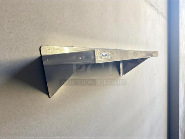 GSW 36” x 14” wall mount shelf in excellent condition, stainless steel. Wall-mounted with visible label detailing brand and specifications.