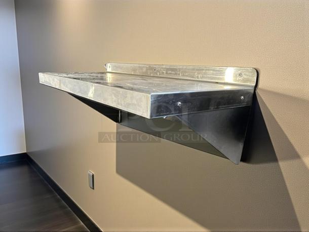 GSW 36” x 14” wall mount shelf in excellent condition, made of stainless steel, with visible sturdy brackets.